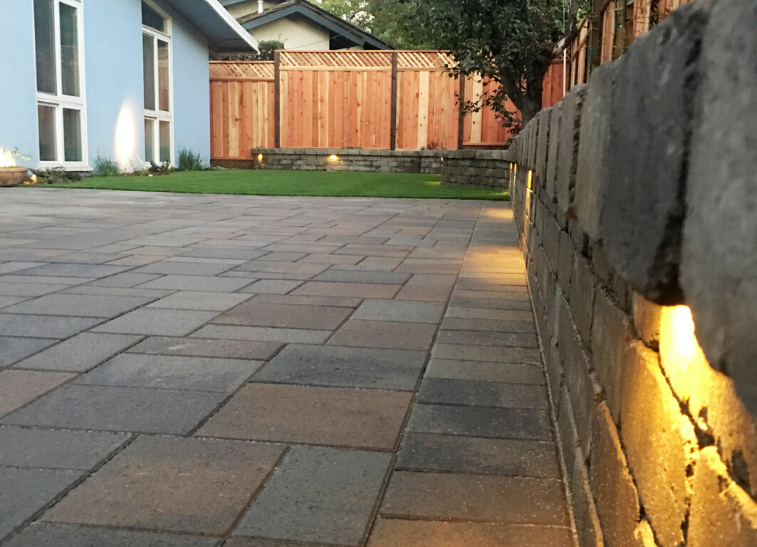 Concrete patio installation with retaining wall and lighting in Norwalk, CA